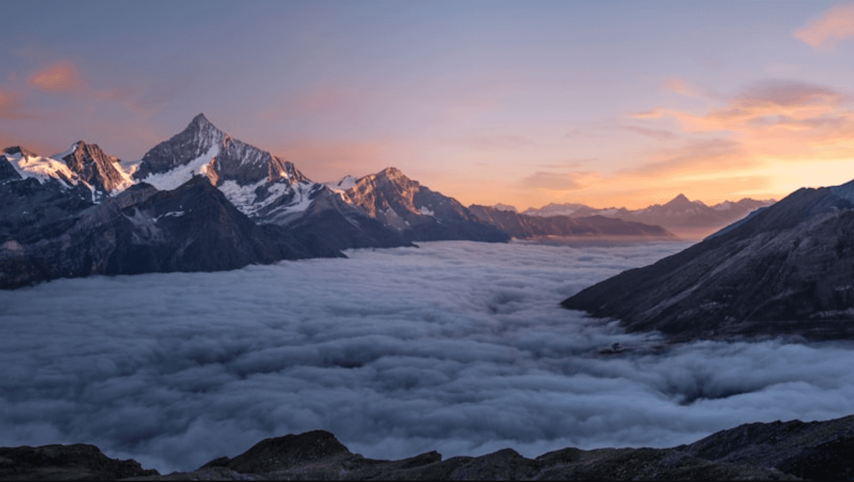 Photographer capturing perfect golden hour mountain landscape